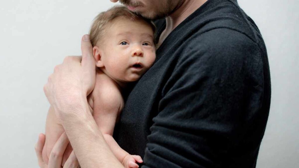 father holding the baby
