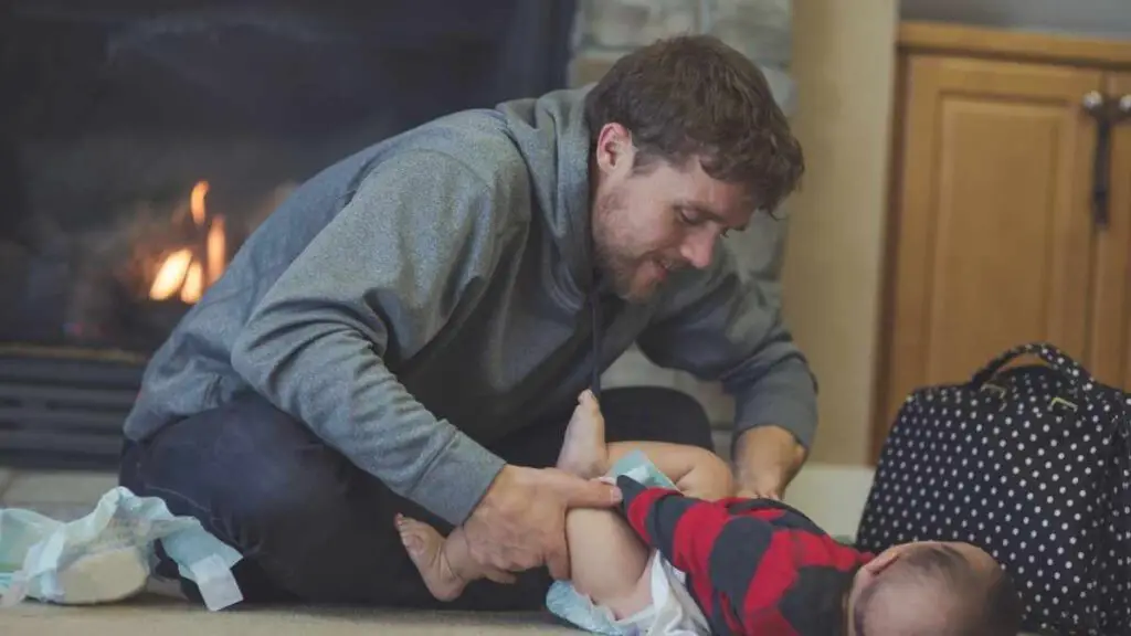 husband changing diaper