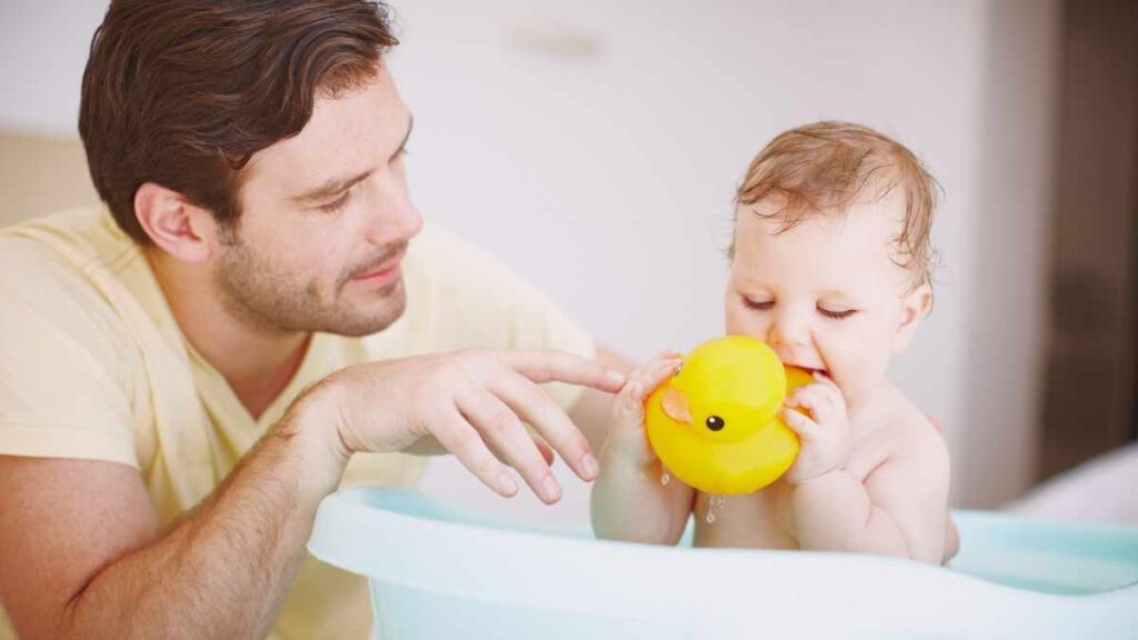 husband with baby in bath