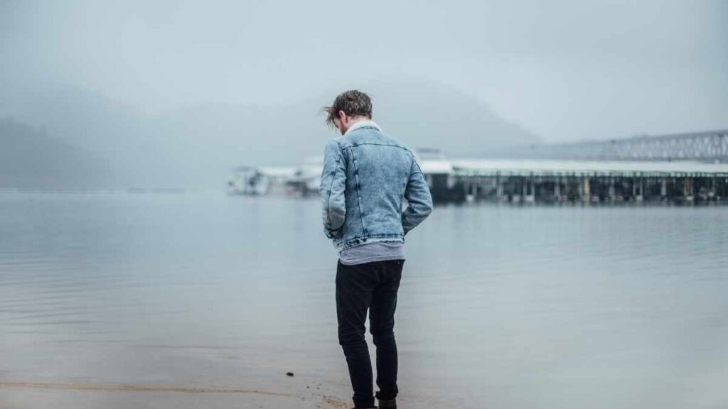 man alone stepped away from everything on a beach