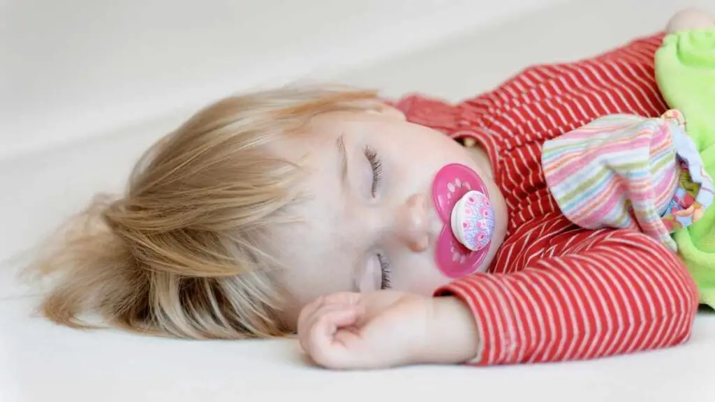 toddler asleep with pacifier