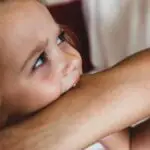 toddler biting moms arm