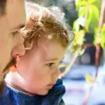 toddler engaged outside with dad