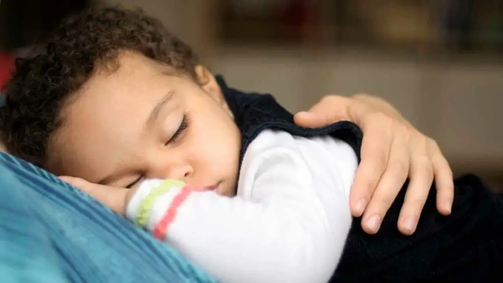 toddler sleeping on mom