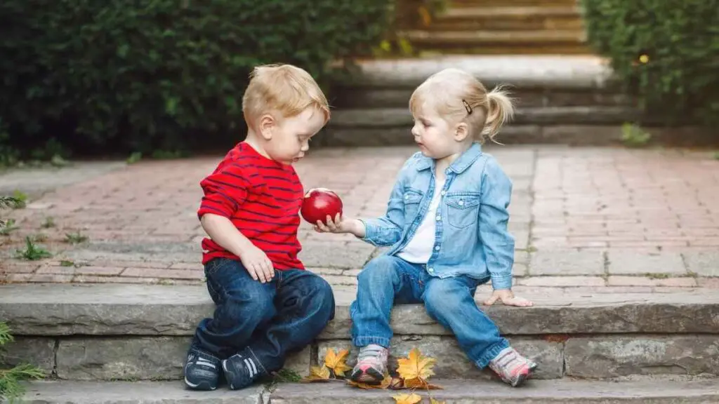 toddler friends sitting on curbside