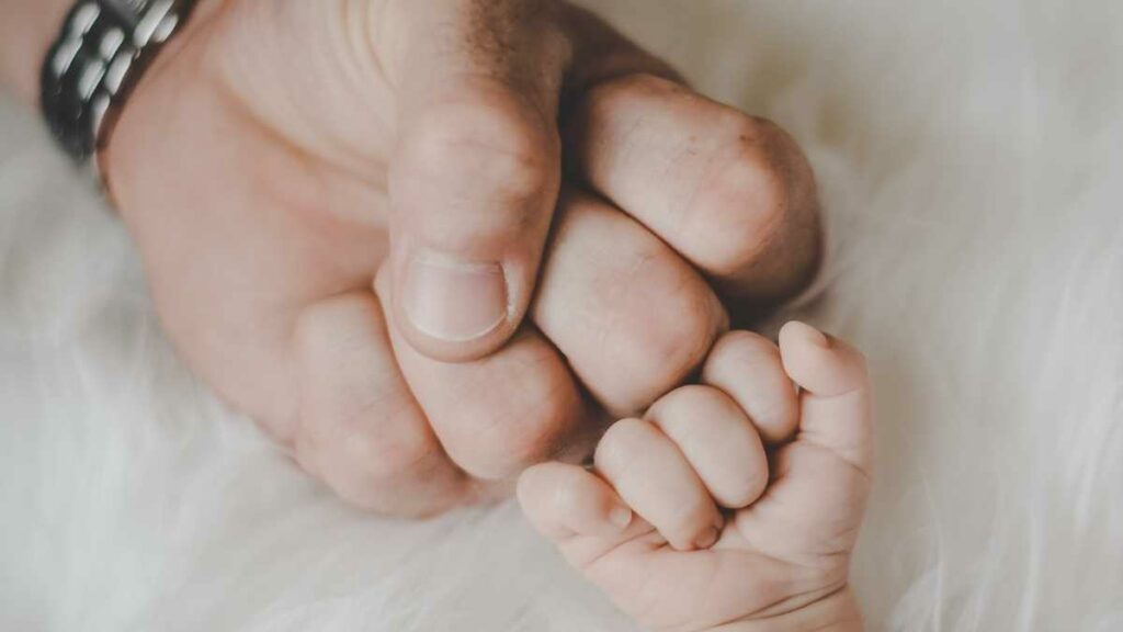 dad and baby fist bump