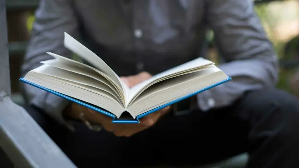 man reading a book researching