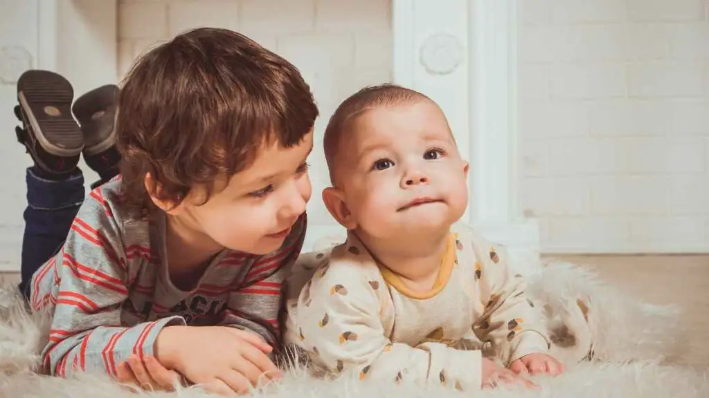 toddler with baby