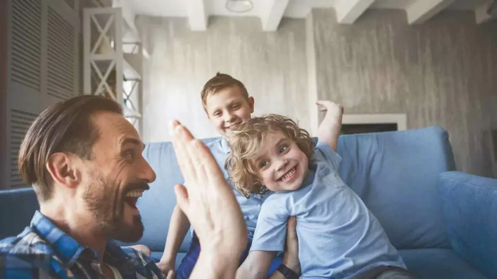 dad playing with two boys