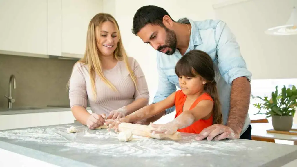 mom and dad cooking with daughter