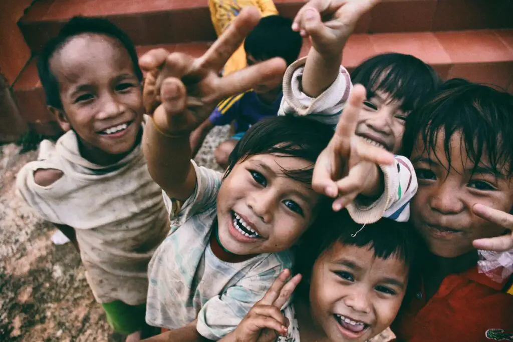 A group of diverse children smiling and holding hands, representing the concept of nurturing healthy self-esteem in children.