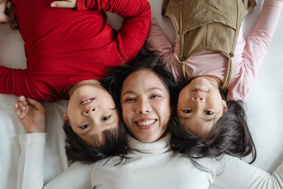 A smiling mother and father happily engaging in a conversation while their child looks on with joy.